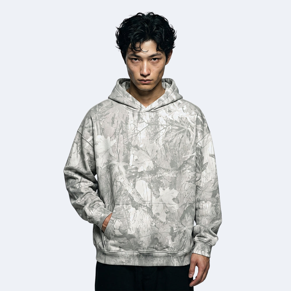 Frost. A man wearing a light gray and white abstract patterned hoodie.