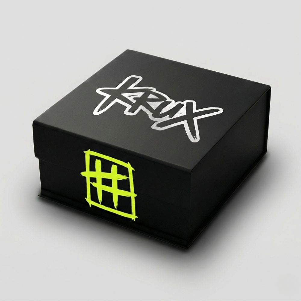 Black box with white and green designs on a gray background