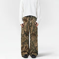 Person wearing camouflage pants and a white shirt on a white background