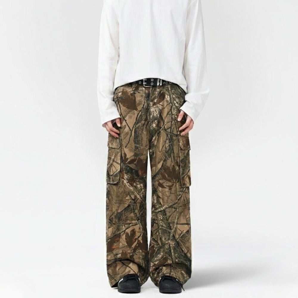 Person wearing camouflage pants and a white shirt on a white background