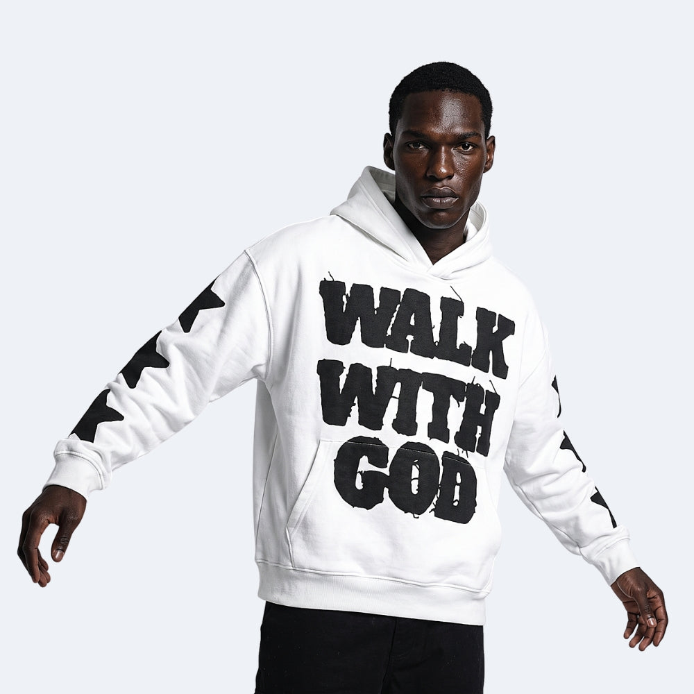 White. A man wearing a white pullover hoodie with bold black text reading WALK WITH GOD across the front and black star-like graphics down both sleeves.