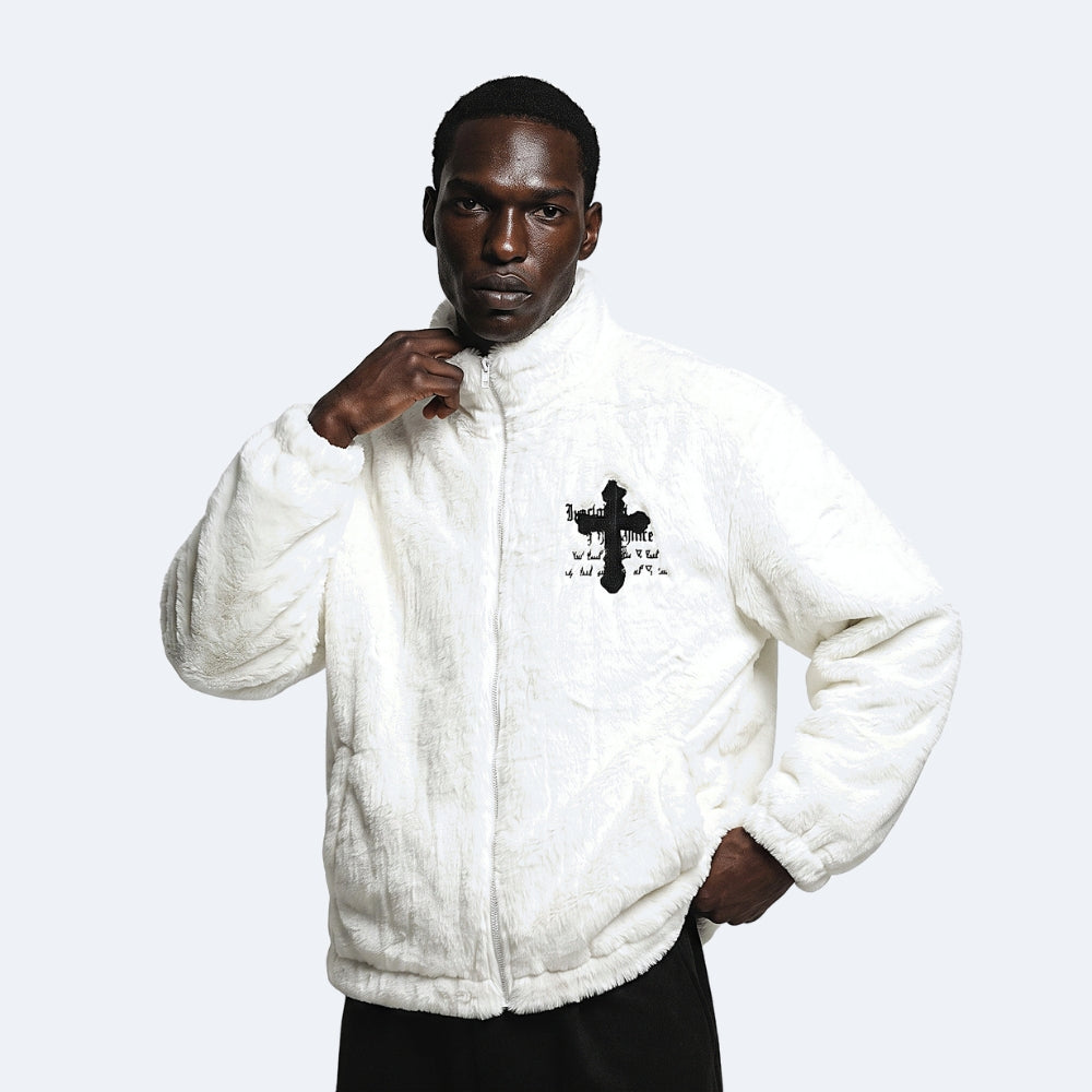 White. A man wearing a white sherpa zip-up jacket with a black cross graphic on the chest.