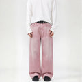 Person wearing a white long-sleeve shirt and pink wide-leg pants on a white background