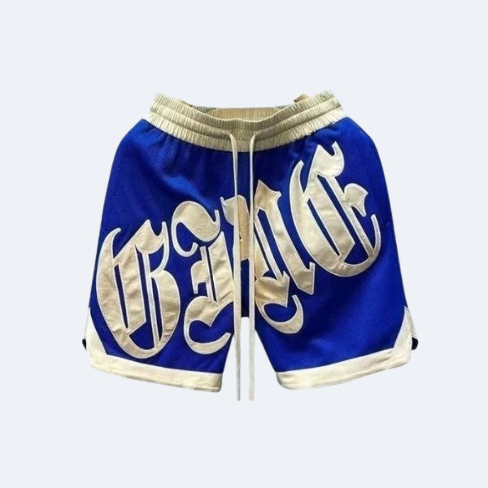 Blue. Blue mesh athletic shorts with a cream drawstring, cream trim, and large cream Gothic lettering across the front.