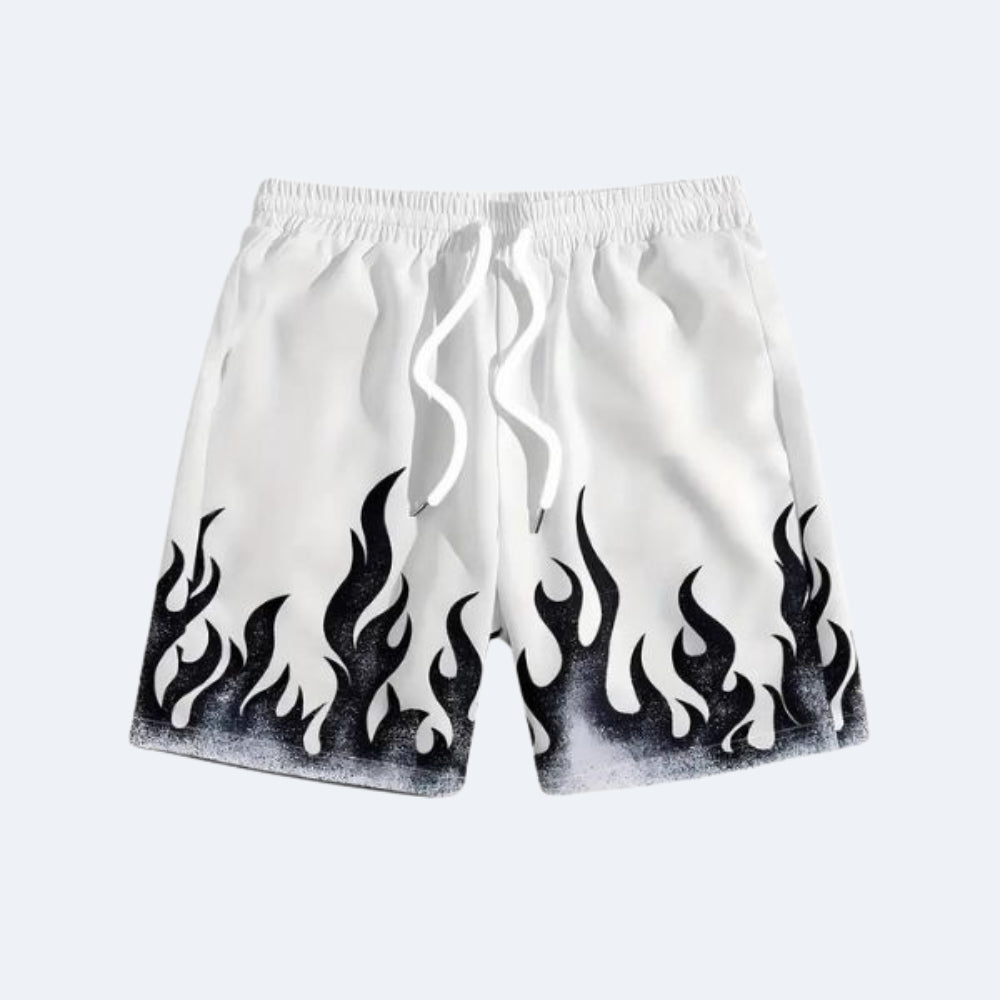 White. White athletic shorts with a black flame print along the bottom hem and a white drawstring.