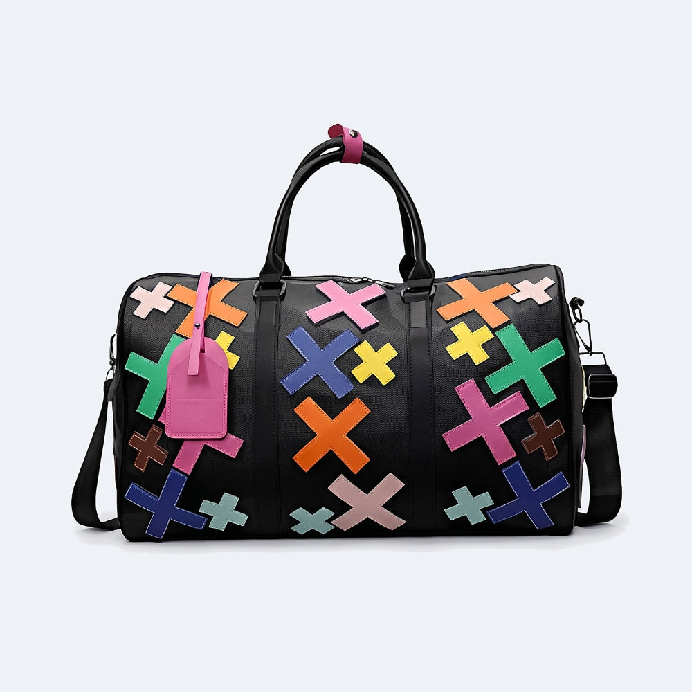 Multicolor. KRUX Crossover duffle bag in black with colorful X appliques, flat lay with shoulder strap