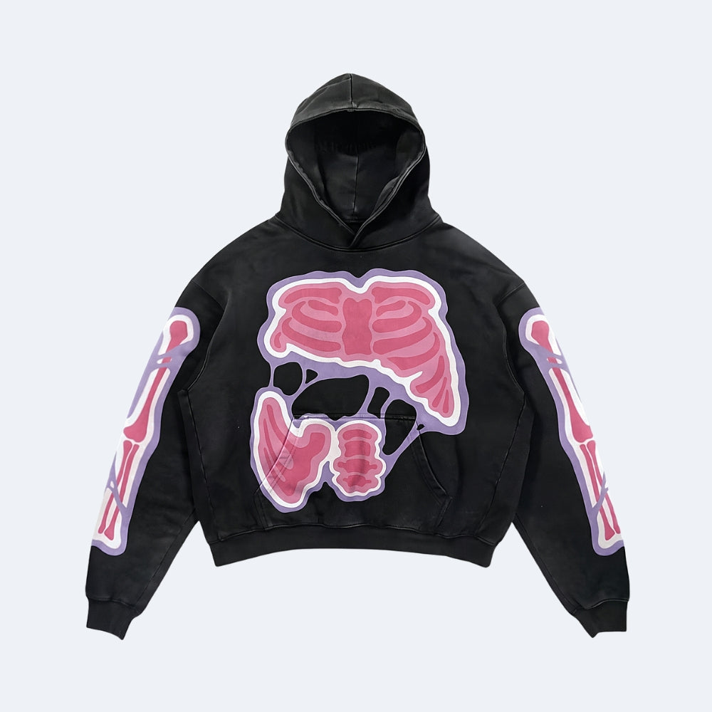 A black cropped hoodie featuring a large pink anatomical rib cage graphic on the chest and matching pink skeletal arm graphics on both sleeves, shown against a light gray background.