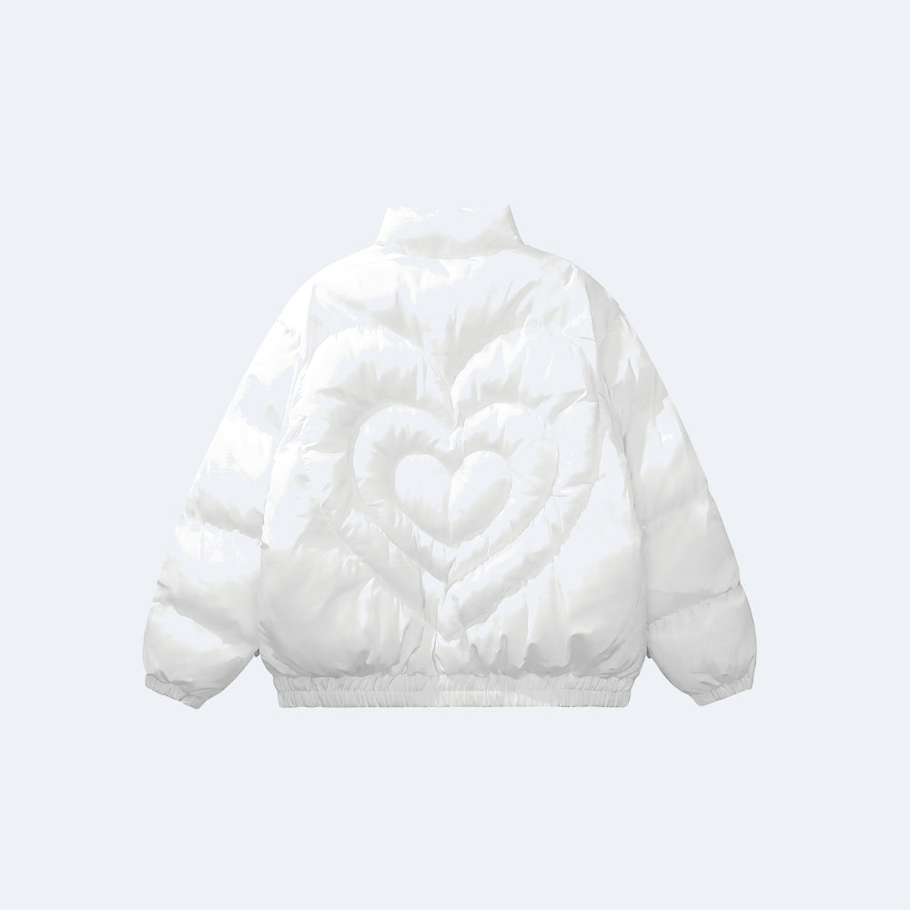 White. A white puffer jacket shown from the back, featuring a large quilted heart design on the back panel and elasticated cuffs and hem.