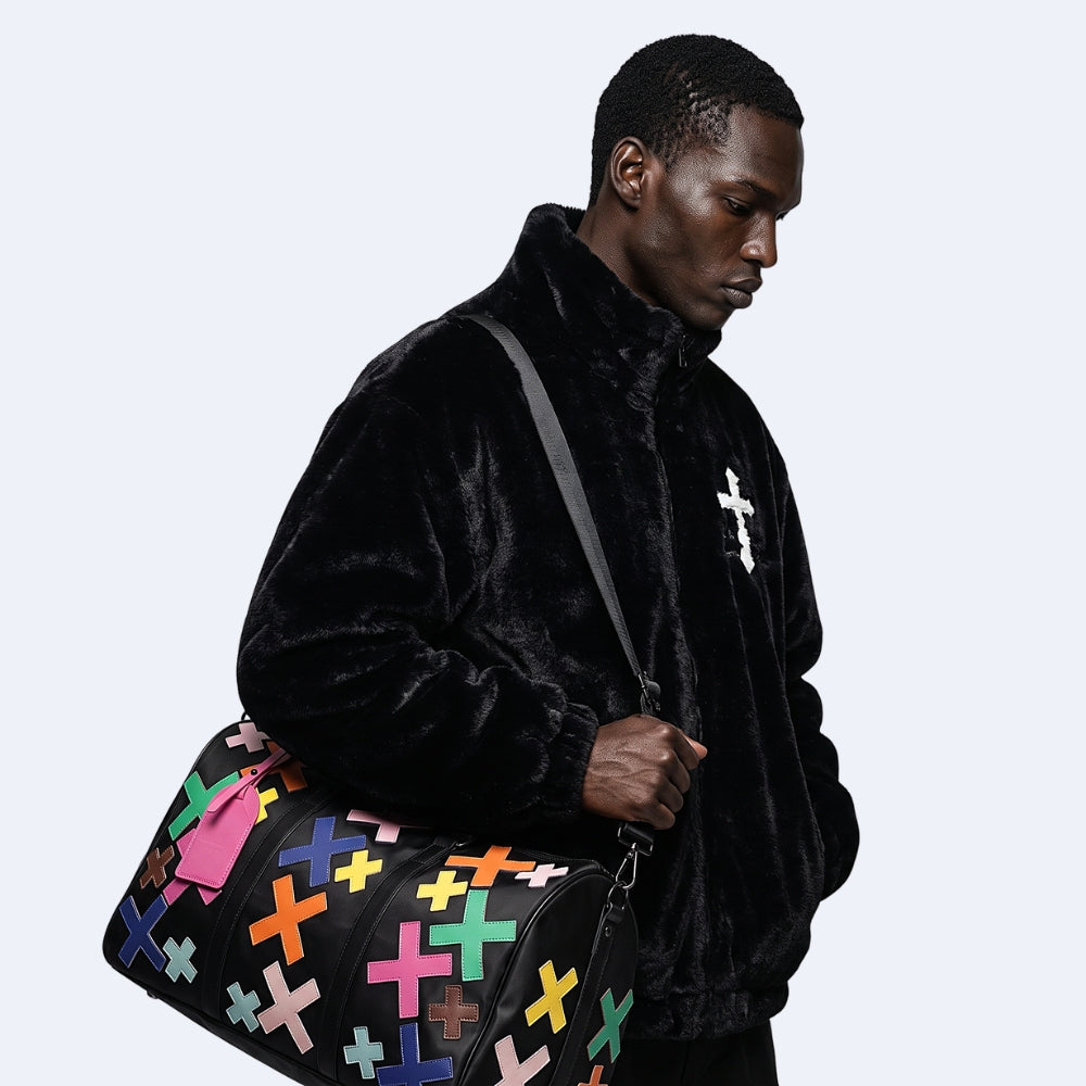 Multicolor. KRUX Crossover duffle bag with embroidered colorful crosses, carried by a model