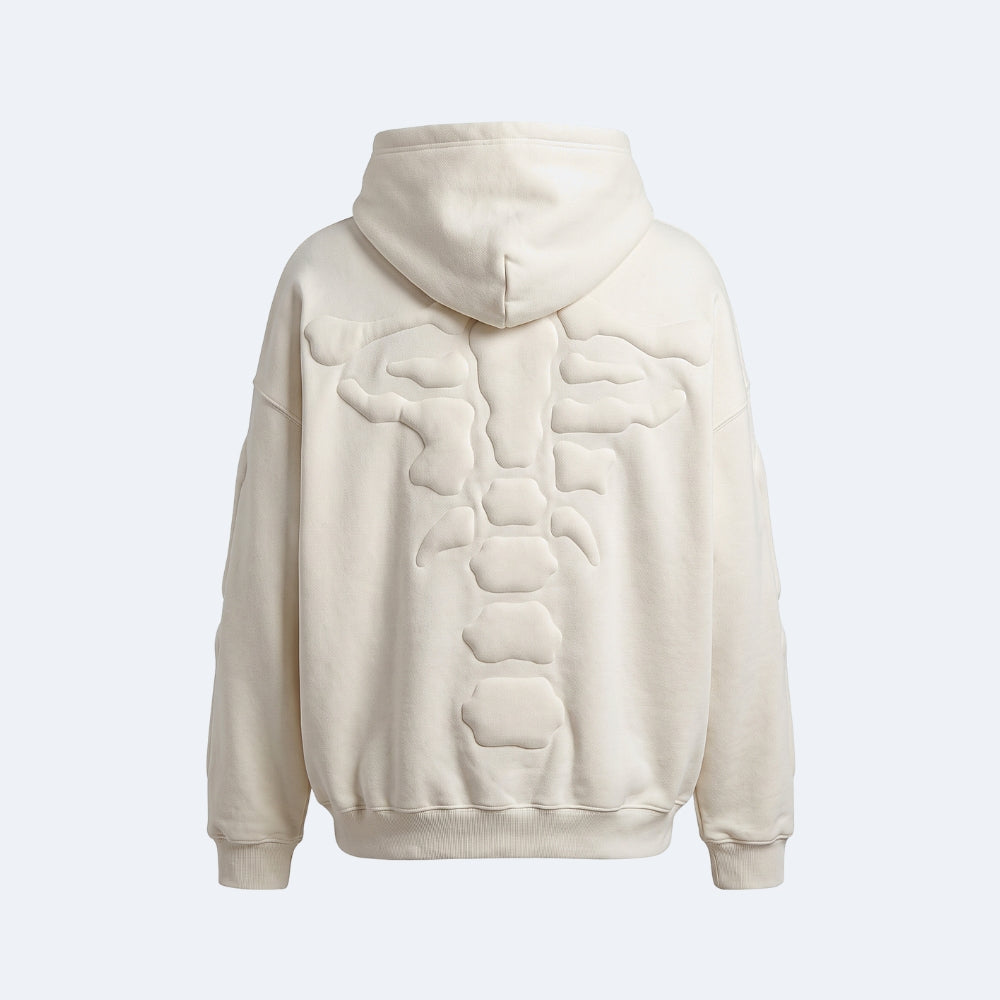 White. An off-white hooded sweatshirt shown from the back, featuring a large 3D sculptural spine design across the back panel.