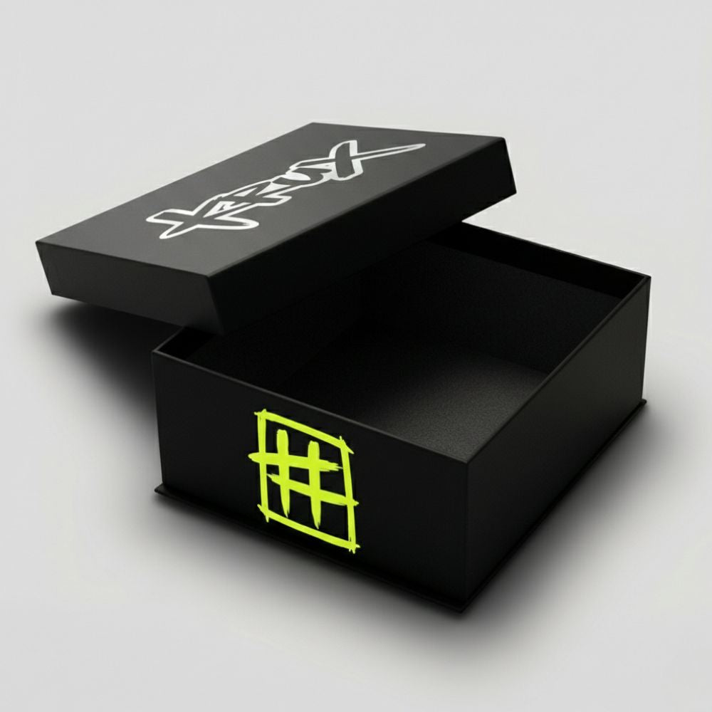 Black open box with white and green designs on a gray background