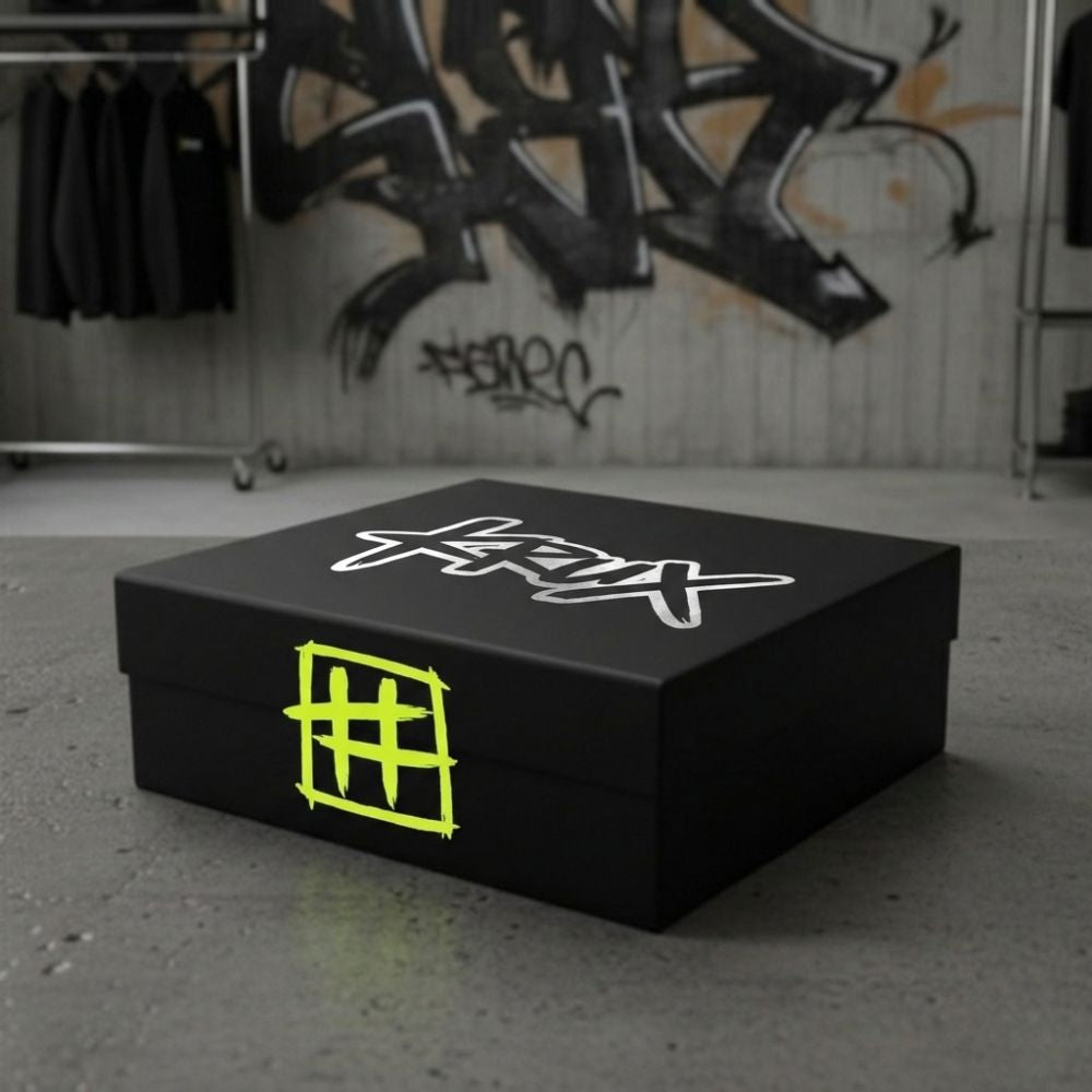 Black box with a logo on a concrete floor with graffiti in the background
