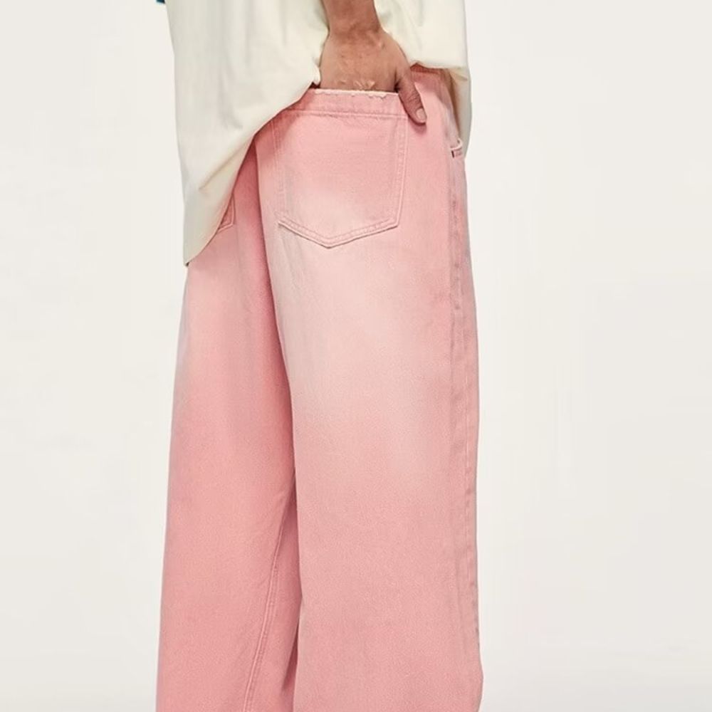 Pink pants worn by a person on a white background