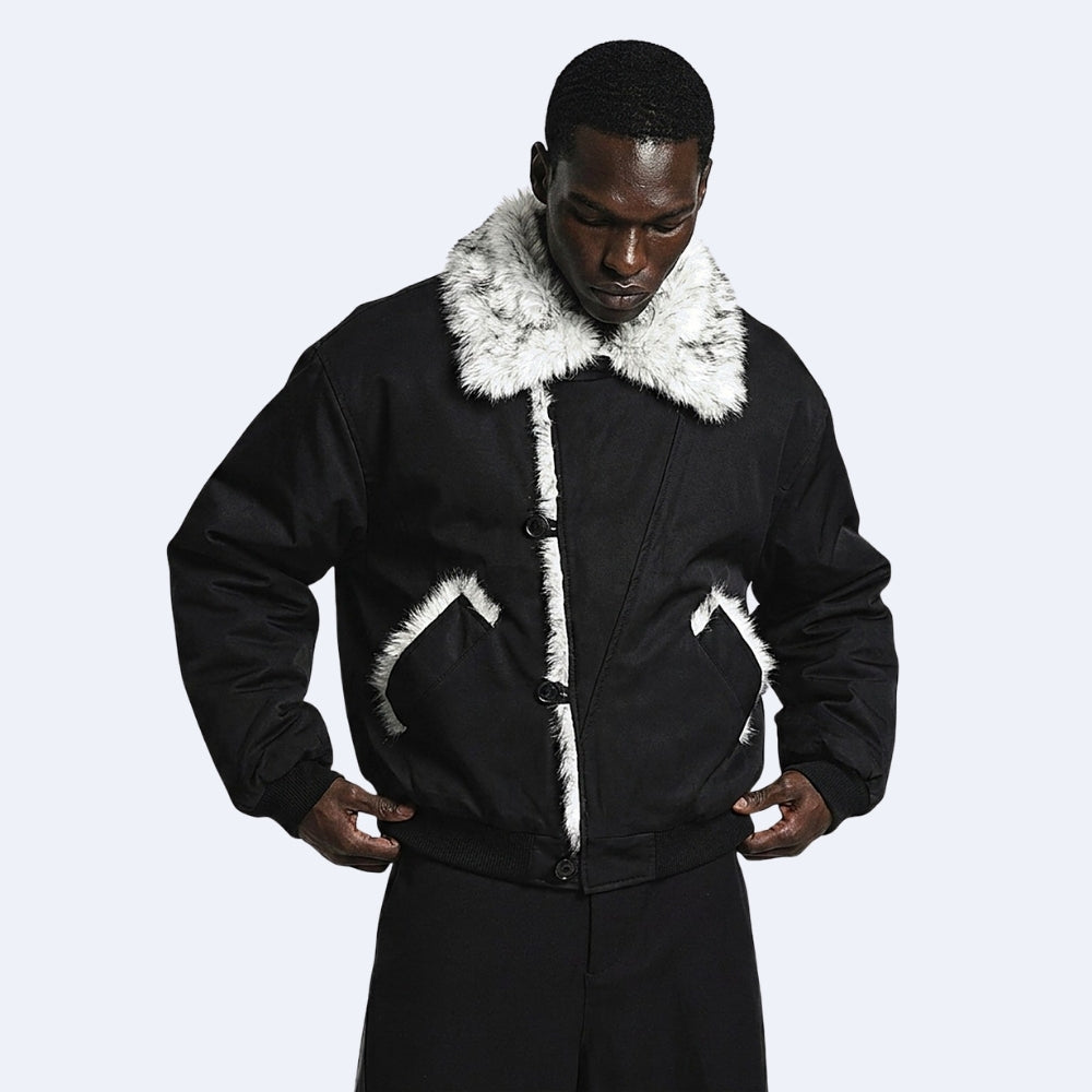 Black. KRUX Blizzard faux-fur bomber jacket in black, worn by a male model — front view with white fur collar and trim