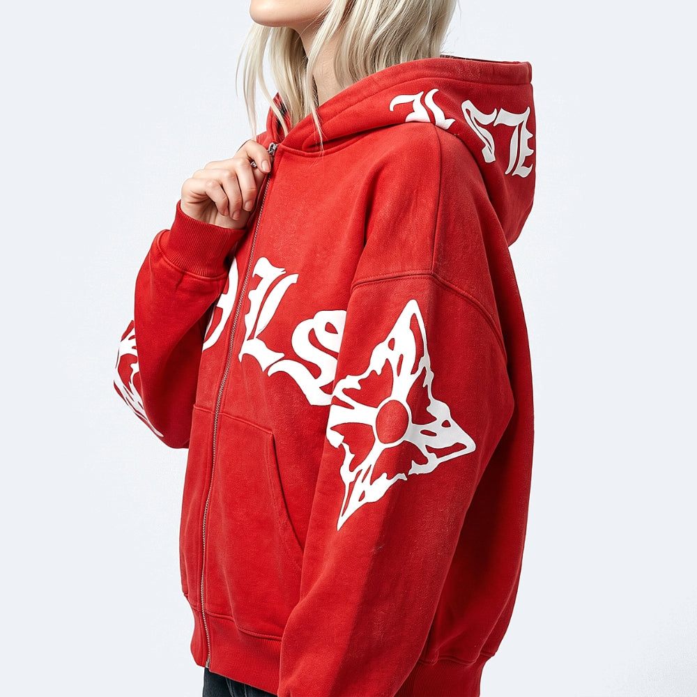 A red zip-up hoodie with white gothic-style lettering and a white butterfly graphic on the sleeve, shown on a model against a light gray background.