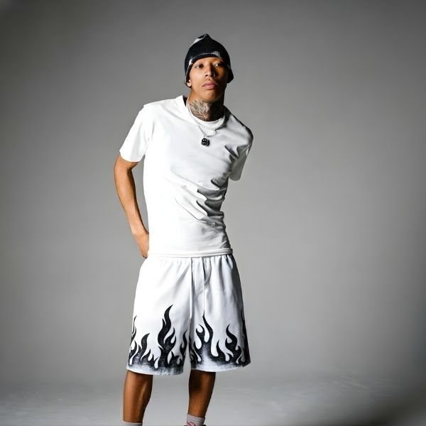 White. A person wearing a white outfit with flame patterns on the shorts.