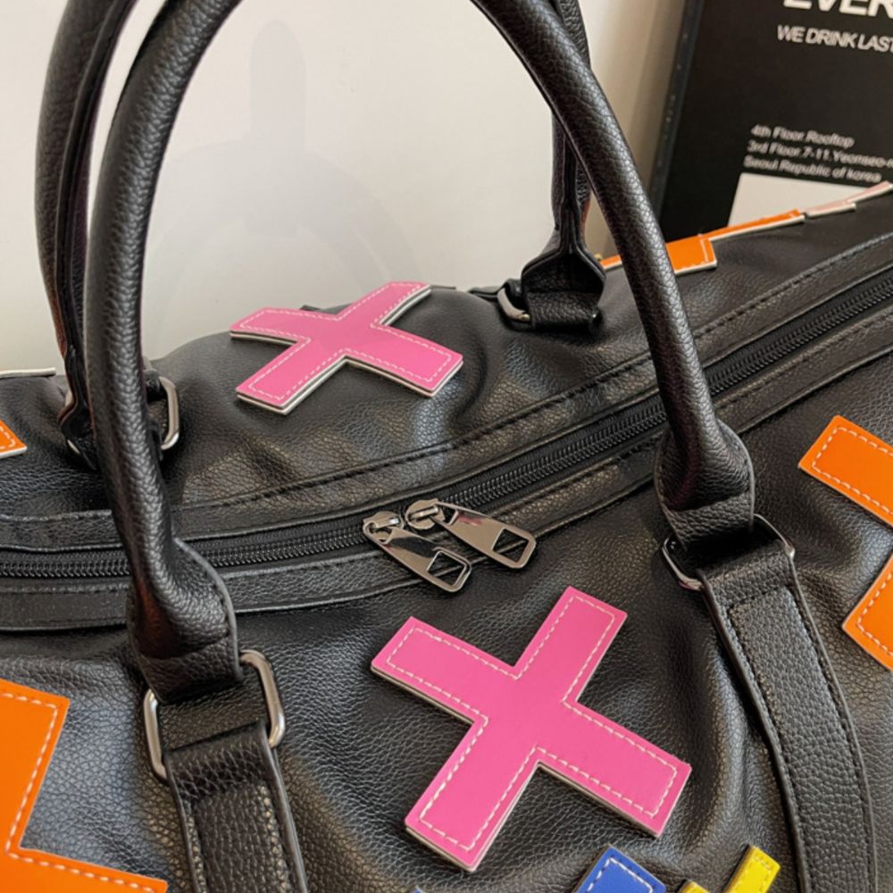 Multicolor. KRUX Crossover duffle bag in black leather with a pink X and colorful accents