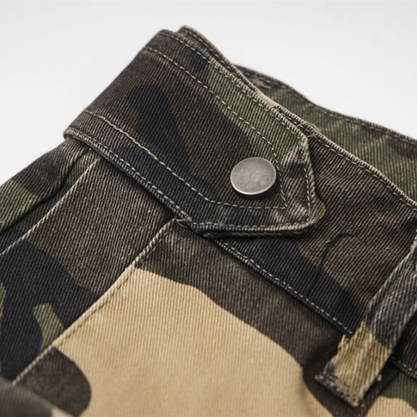 Close-up of a camouflage jacket with a button on a light gray background