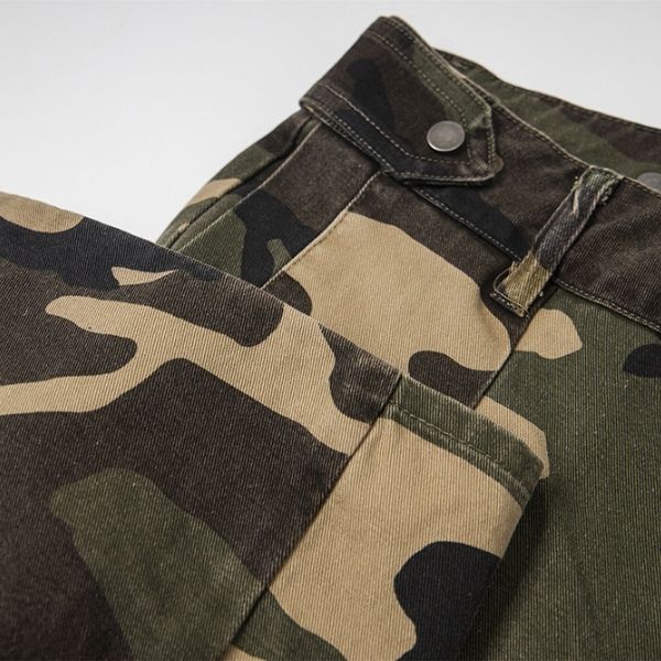 Camouflage pants with a button and zipper on a light gray background