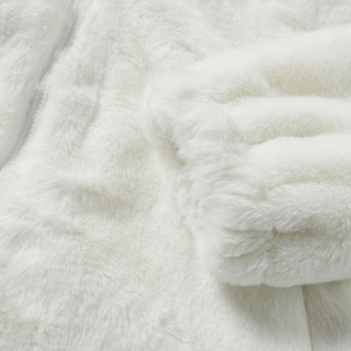 White. A close-up of a white fluffy textured surface.