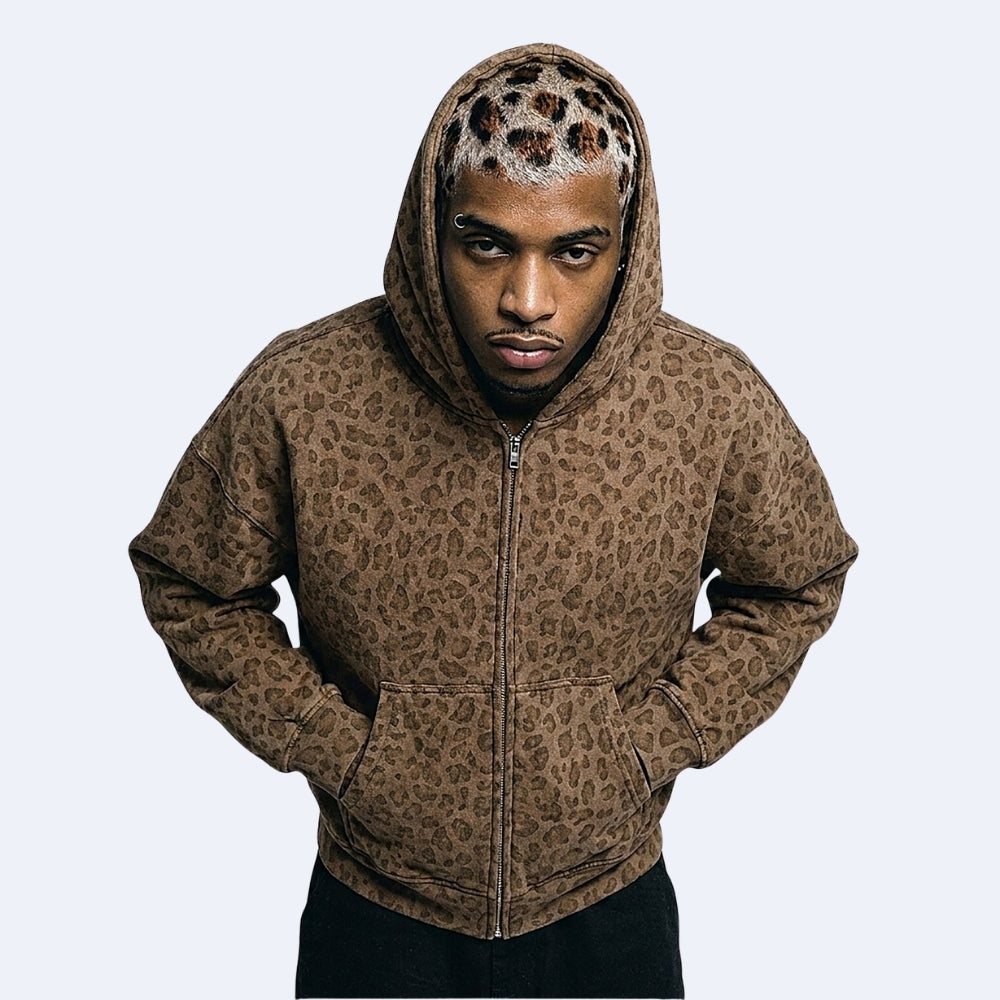 Brown. KRUX Feral brown leopard-print zip-up hoodie on a male model, hood up front view