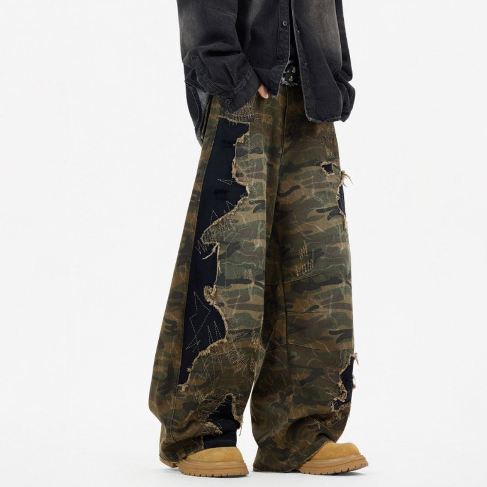 Camouflage pants with a black jacket and brown shoes on a white background