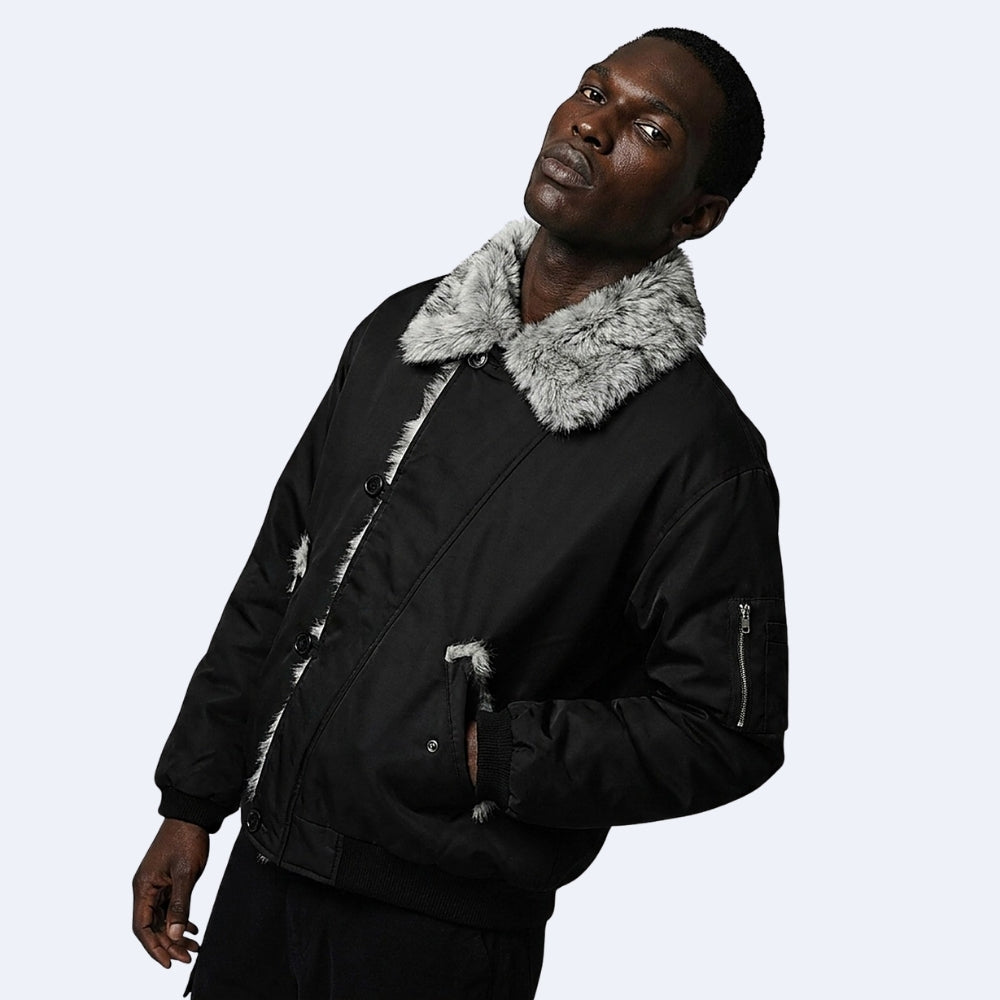 Black. KRUX Blizzard black fur bomber on a male model, side view showing zip sleeve pocket and fur collar