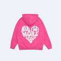 Pink. A bright pink hoodie shown from the back, featuring a large white retro-style graphic text that reads MANIFEST MORE LOVE across the back.
