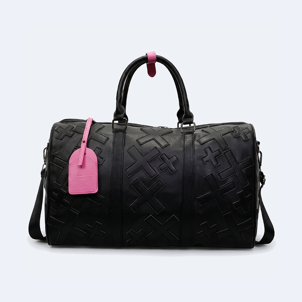 Black. KRUX Crossover duffle bag in black, flat lay with embossed monogram, dual handles and pink tag