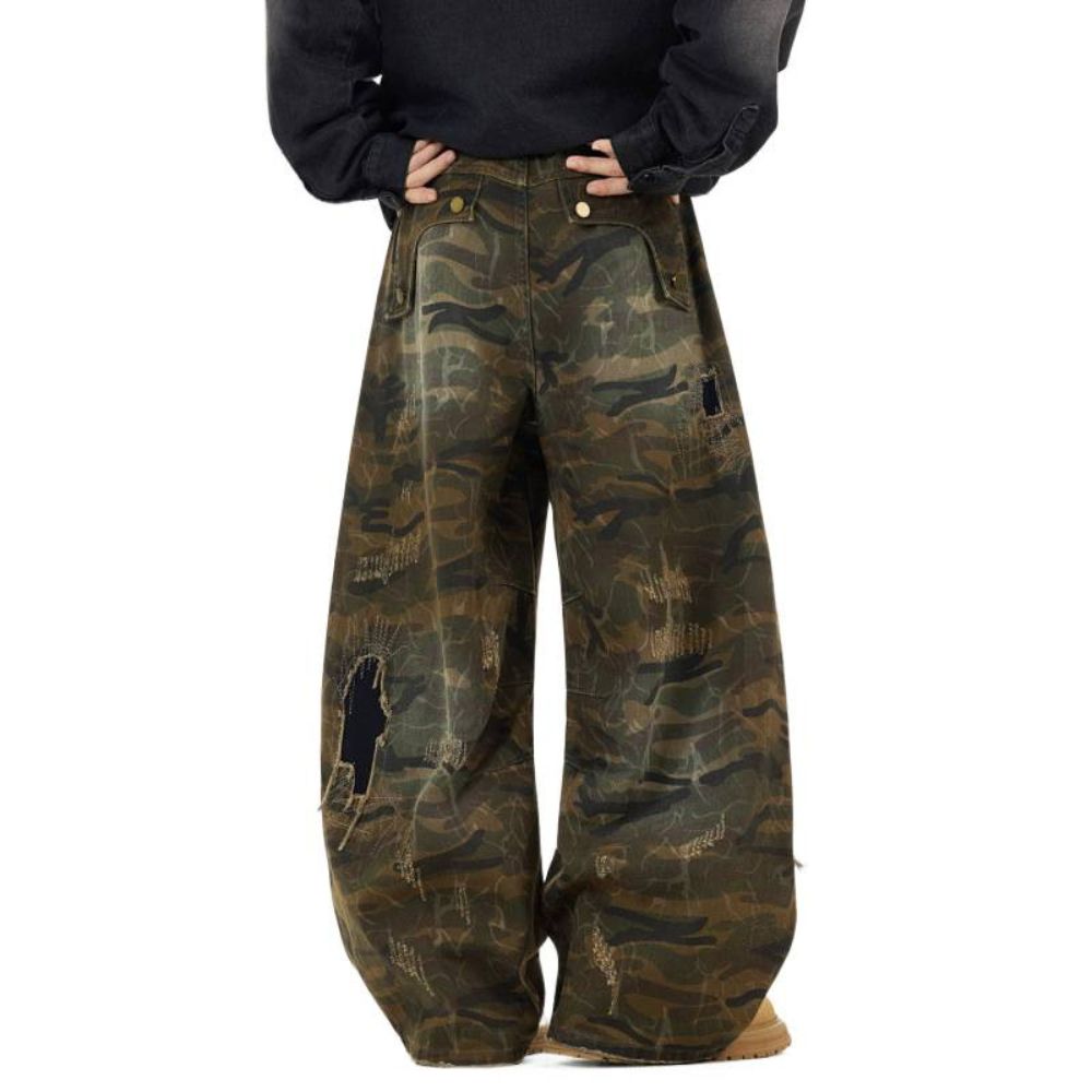 Camouflage pants worn by a person on a white background