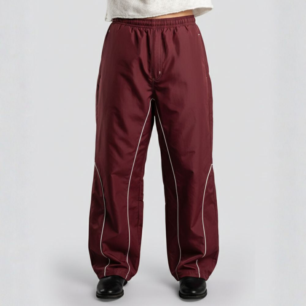 Maroon pants with white piping on a light gray background