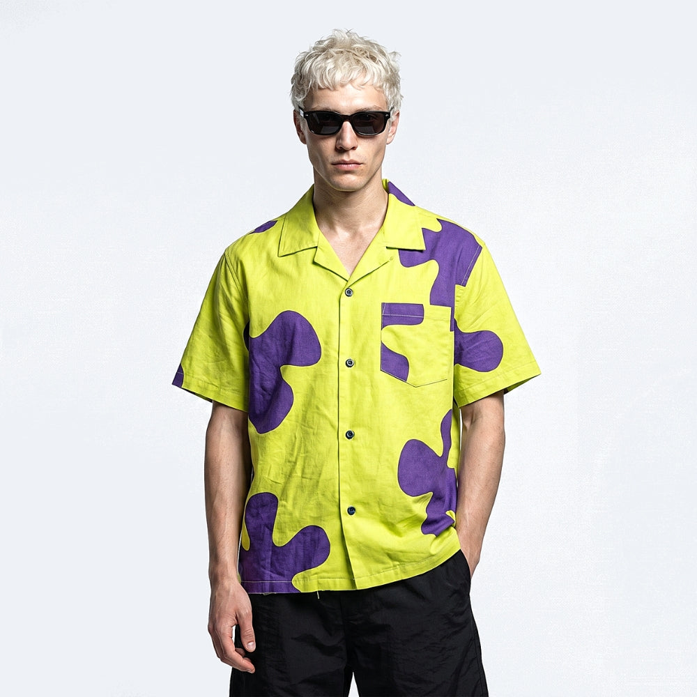 Yellow & Purple. A bright yellow short-sleeve button-up shirt with bold purple abstract patterns.